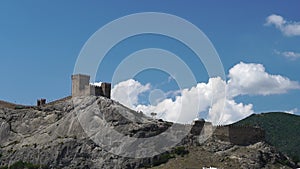 Genoese fortress in Sudak. Crimea. Fragment of medieval fortress wall against background of blue sky