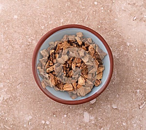 Gentian root in a small bowl on a marble table