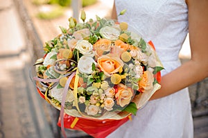 Gentle and beautiful wedding bouquet in woman hands