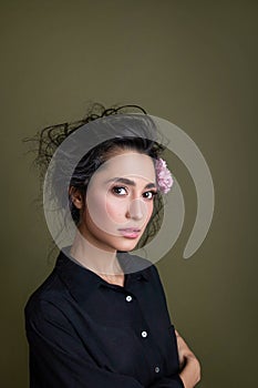 Gentle beauty portrait of beautiful young female. Girl dressed in black shirt. Gentle makeup. Woman look at camera.