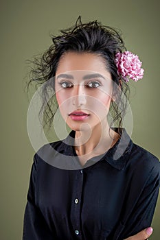 Gentle beauty portrait of beautiful young female. Girl dressed in black shirt. Gentle makeup. Woman look at camera. Fashion style