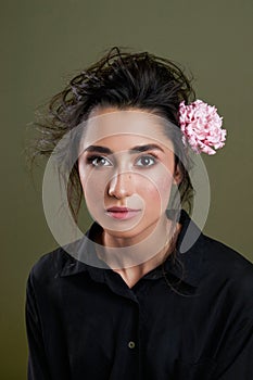 Gentle beauty portrait of beautiful young female. Girl dressed in black shirt. Gentle makeup. Woman look at camera. Sensual