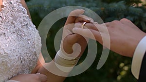 Gentle bride wears the groom`s ring. Wedding ceremony