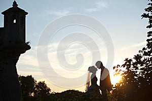 Gentle couple holding hands and kissing on background castle an