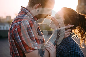 Gentle couple touch. Urban background