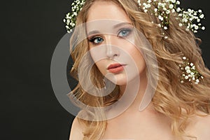 Gentle girl with white flowers on black, beautiful face closeup