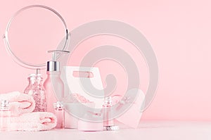 Gentle girlish dressing table with round mirror and cosmetics products - rose oil, bath salt, cream, perfume, cotton towel.