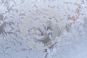 Gentle graceful frosty pattern on winter window glass.