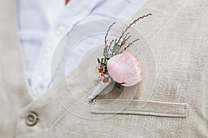 Gentle groom boutonniere with pink rose