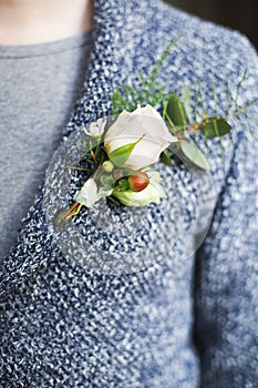 Gentle groom boutonniere with roses and beads