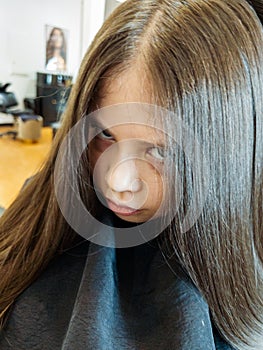 Final Touches with a Hair Dryer on a Little Girl's Fresh Cut photo