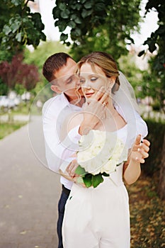 Gentle and happy newlyweds on a walk in the park.