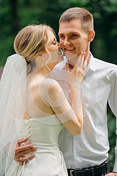 Gentle and happy newlyweds on a walk in the park.