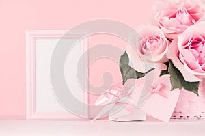 Gentle home decor for Valentines day - roses bouquet, gift box, blank frame, soft light pink heart with ribbon on white wood board