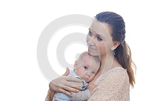 Gentle photo of mother and baby. Mom with love and tenderness hugs her son on a light background