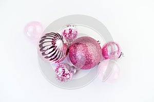 Gentle pink baubles on a white background. Christmas mood
