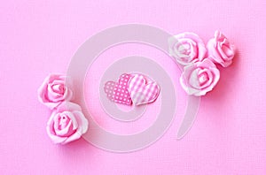 Gentle pink holiday background with two hearts, rose flowers