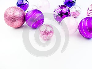 Gentle pink and purple baubles on a white background. Christmas mood. Copy space