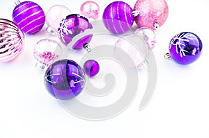 Gentle pink and purple baubles on a white background. Christmas mood. Copy space