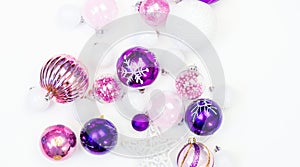 Gentle pink and purple baubles on a white background. Christmas mood. Copy space