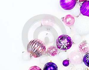 Gentle pink and purple baubles on a white background. Christmas mood. Copy space