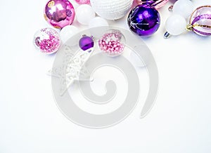 Gentle pink and purple baubles on a white background. Christmas mood. Copy space