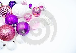 Gentle pink and purple baubles on a white background. Christmas mood. Copy space