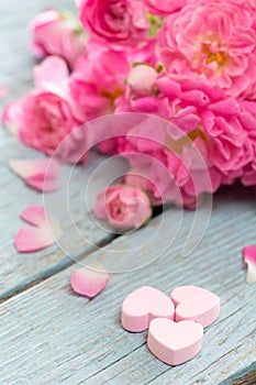 Gentle pink rose and heart on wooden table