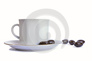 Gentle porcelain tea set - cup and plate with chocolate candies on white background.