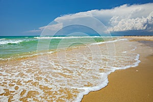 Gentle sea waves on a sandy beach, full frame nature background concept for tourism, vacations and environmental