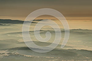 Gentle slopes in haze at dawn in Beskids Carpathians Poland