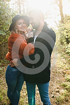 gentle and stylish couple are having a walk in the autumn park.