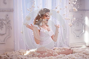 Gentle and sweet pregnant woman in the image of a mother bird in the nest, concept. Young blonde woman