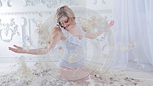 Gentle and sweet pregnant woman in the image of a mother bird in the nest, concept. Young blonde woman.