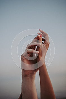 A gentle touch of the hands of a man and a woman on a white background. Love connection help concepts. Be hand in hand.