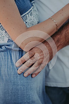 Gentle touch of a man`s hand on a woman`s shoulder