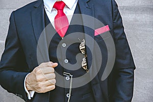 Gentle uniform stylish tuxedo luxury suit with red necktie for modern groom or fashionable business person