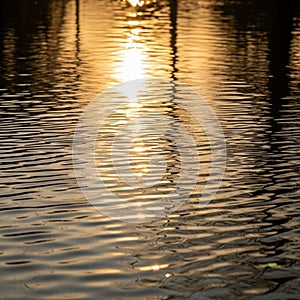 With gentle waves capturing the reflection of the light in a