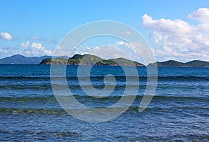 Gentle waves rolling onto a shore of St. Thomas island beach in winter.