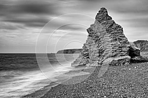 Gentle waves wash towards a sea stack. Seaham