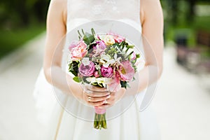 Gentle wedding bouquet in the bride's hands