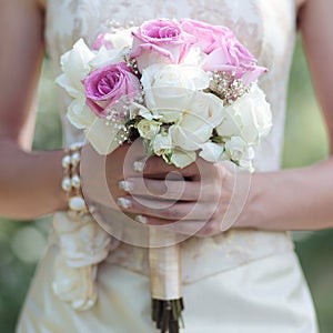 Gentle wedding bouquet of flowers in hands bride