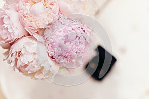 Gentle wedding bouquet peonies with rings background