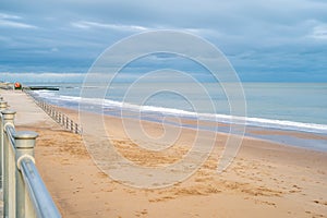 Gentle white surf on Ramsgate main sands. There is nobody on the beach on an autumn day