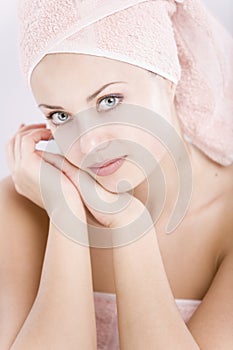 Gentle young woman with towel on her head