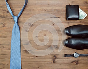 Gentleman concept. tie dollars watches and shoes