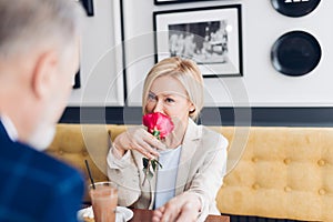 Gentleman pays compliments to blond attractive woman