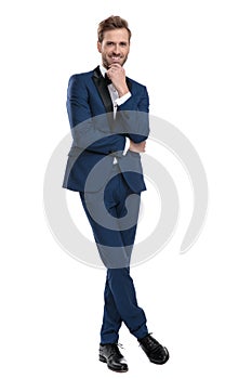 Gentleman is thinking with legs crossed and hands folded