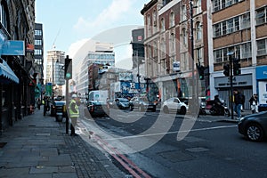 A gentleman waiting patiently to cross the street in trendy Shoreditch, Uk