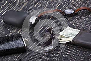 Gentlemanly set: sunglasses, perfume, wallet, flask, watch on wooden background